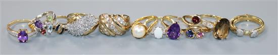 Eleven assorted 9ct gold gem set rings, including diamond, amethyst and opal,